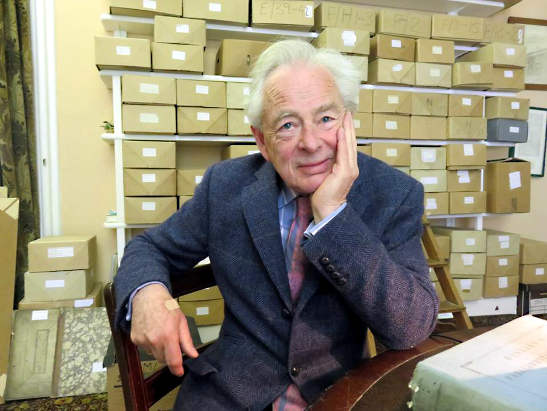 the 7th Earl of Rosse, Brendan Parsons, in a room full of documents relating to his ancestors