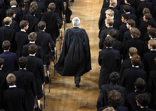 students stand at Eaton as the headmaster enters the hall
