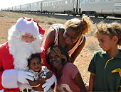 Santa with native Australian on an Indian Pacific Christmas train stop
