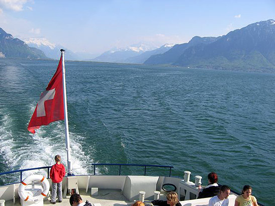 view of Lake Geneva from a paddleboat with the French Alps in the background