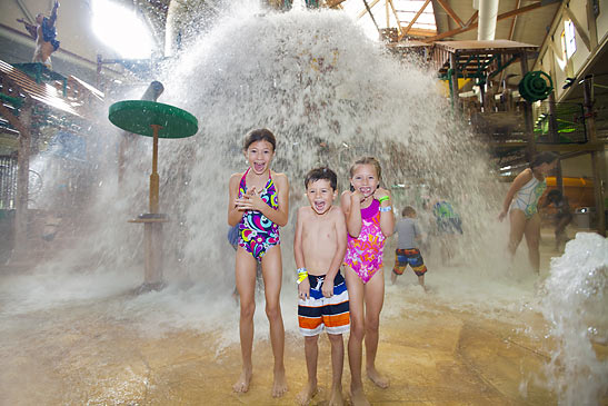 overhead bucket tips over at young guests at the Great Wolf Lodge waterpark
