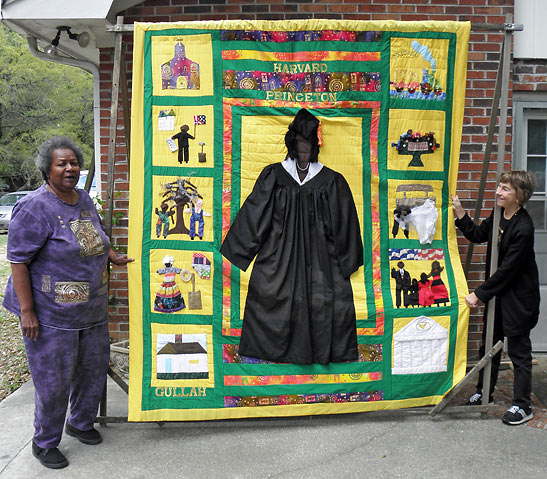Bunny Rodrigues and author with large quilt re-telling Michelle Robinson Obama's family history