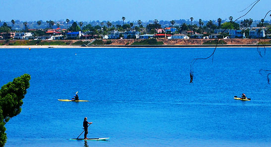 view of kayakers and paddle boaters at Mission Bay from Bahia Resort hotel room