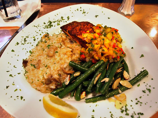 Cajun-styled salmon with mango salsa served with mushroom risotto and blue lake beans almondine at Cafe Bahia