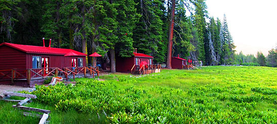 red cabins at a meadow behind a thick forest, Drakesbad Guest Ranch, Lassen Volcanic National Park