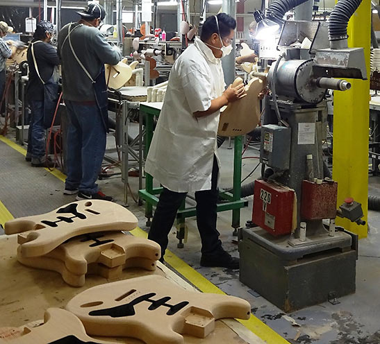 Fender guitar craftsmen at work in the metal shop