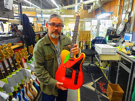 showing off a finished Fender guitar