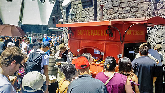 visitors queuing up at a Butterbeer cart