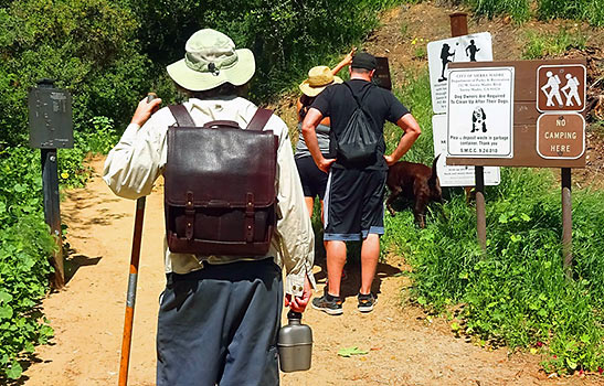 Orvis sun hat, safari shirt and bison leather backpack on a traveler