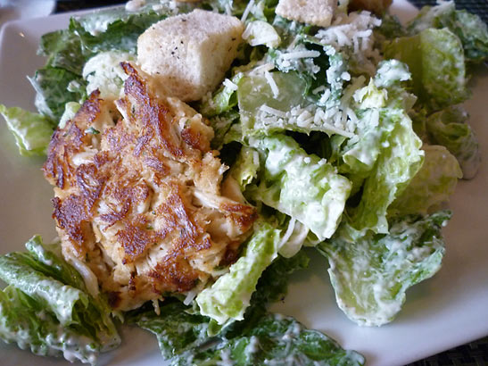 crab cake over a Caesar salad at the Share Restaurant