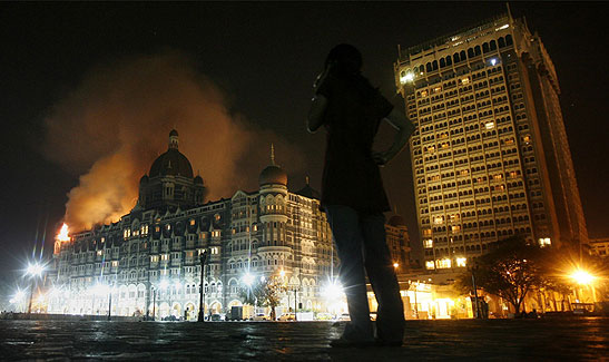 the Taj Mahal Hotel in flames at night