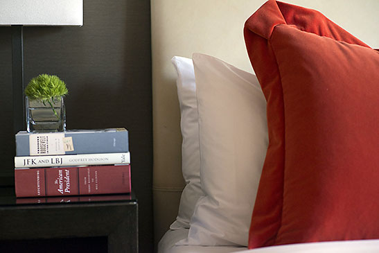 books next to bed at the Dupont Circle Hotel