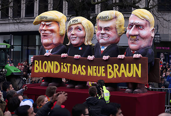 a Dusseldorf parade float of Trump with Marine Le Pen, Geert Wilders and Adolf Hitler