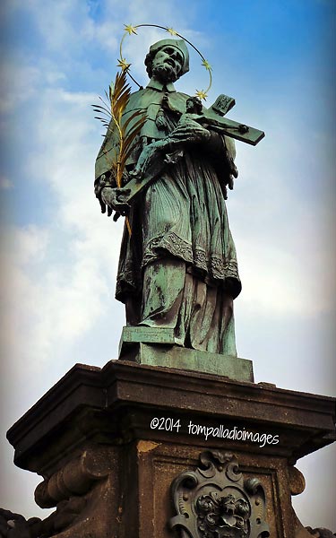 statue of St. John of Nepomuk lining the side of the Chrles Bridge