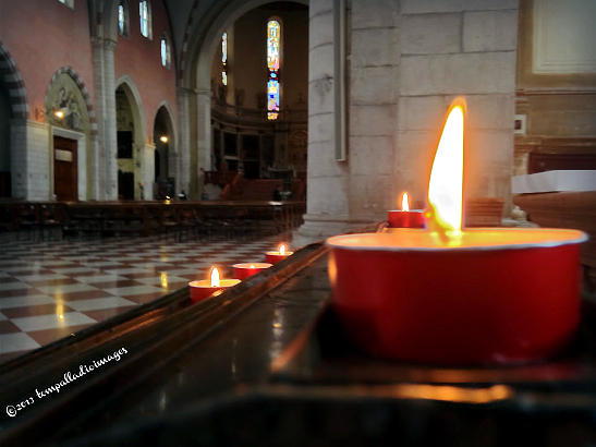 lighted candle inside il Duomo