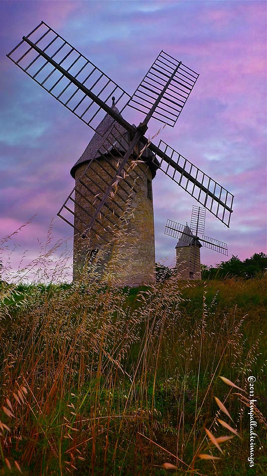 two vintage windmills at the village of Montagne