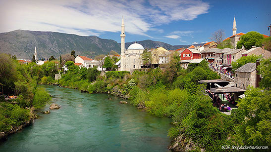 a mosque and other buildings on the banks of the Neretva River