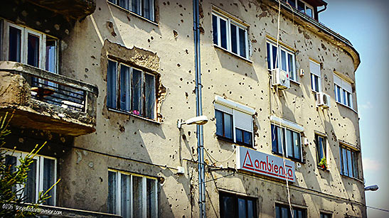 building riddled by rifle and mortar fire from the Siege of Sarajevo in the 1990s