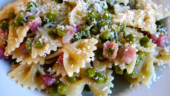 grated cheese on farfalle dish