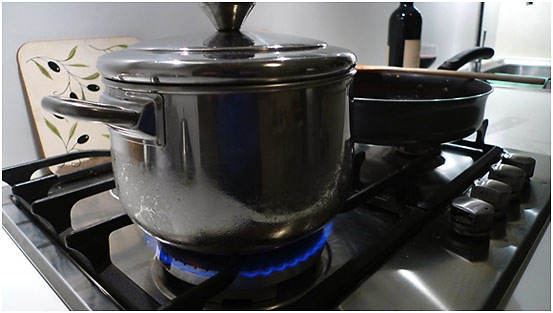 covered pot of water on stove