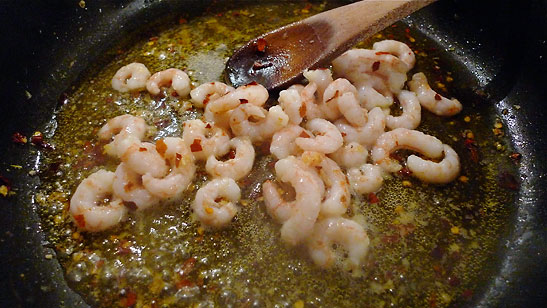 shrimp added to garlic, red pepper, olive oil mix