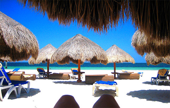 thatched roof shades on beach, Excellence Riviera Cancun