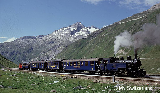 the Glacier Express steam train with Swiss alpine scenery in the background
