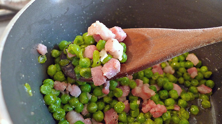 peas added to pancetta in skillet