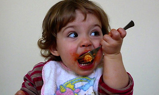 Italian kid enjoying her plate of pasta