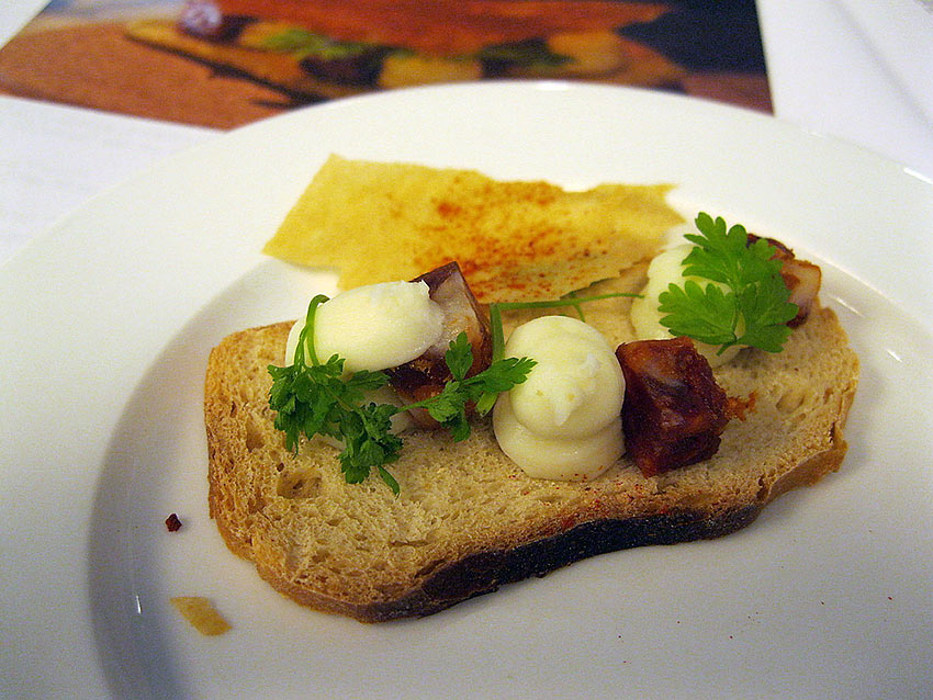 creamed local cheese and diced chorizo, garnished with stems of chervil and topped with a thin wafer on bread