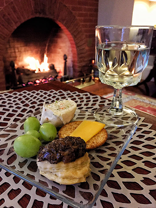 appetizers and fireplace in a Cheshire Cat Inn room