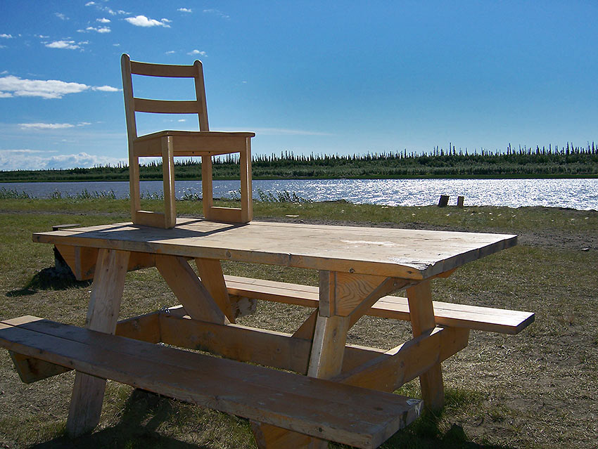 table and chair beside the McKenzie River