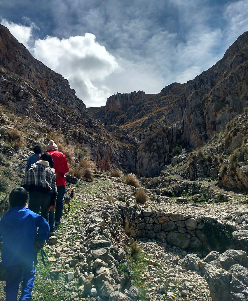 hiking past rocks used as an ancient shelter