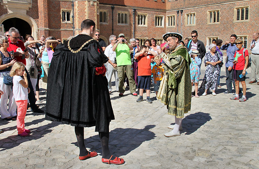 docents at the Hampton Court Palace courtyard offer colorful history