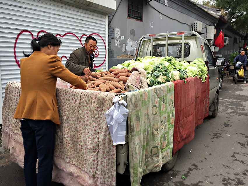 sweet potatoes, cauliflower, and lettuce driven directly from a farm and sold from the back of a truck in one of Beijing’s ancient rundown hutongs or connecting courtyards