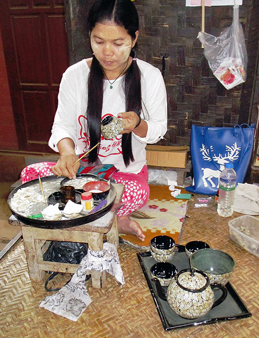 woman making yellow paste from Thanaka bark