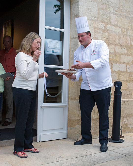 Chef Daniel Papadimas, offering chocolate to a guest at Chateau Kirwan