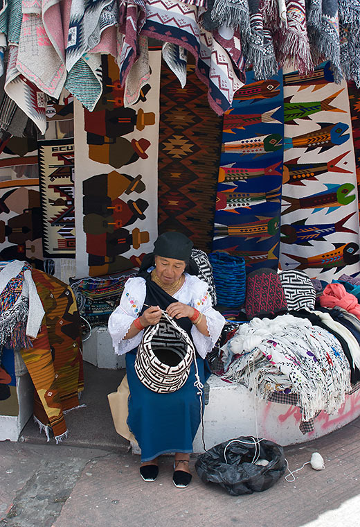 a weaver and her products at Otavalo's Craft Market, Plaza de Ponchos, Quito