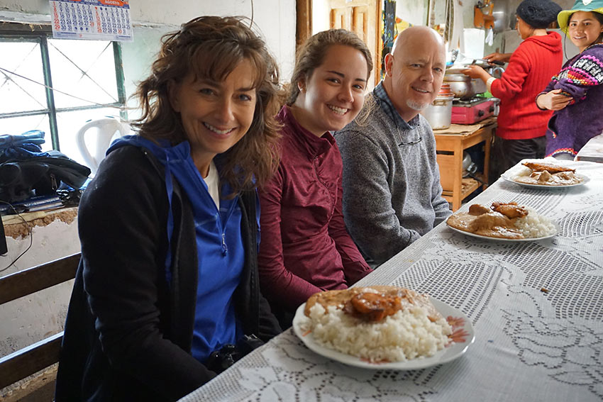 author's family trying cuy con maní (guinea pig with peanut sauce) for lunch