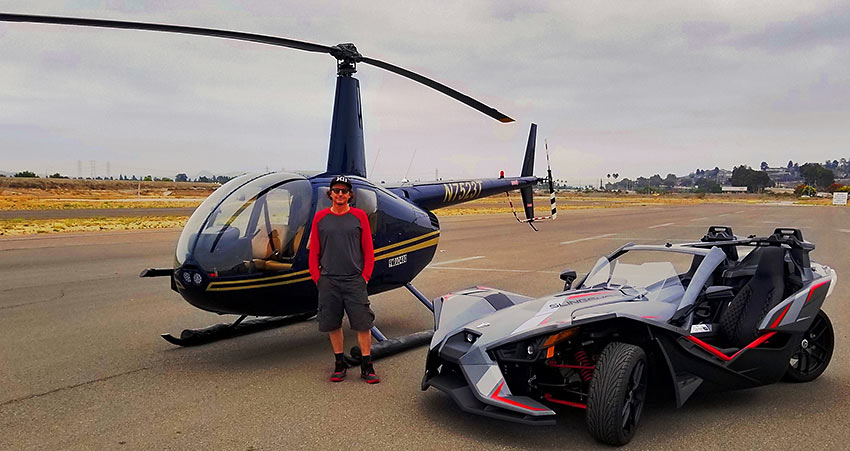 writer with helicopter and Polaris Slingshot at Oceanside