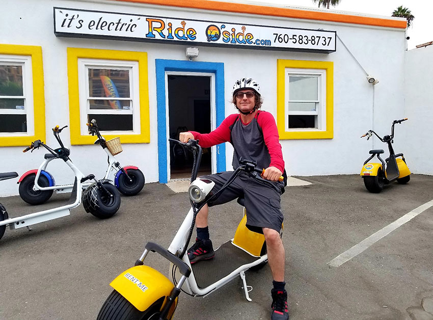 writer with fat tire electric scooter, Oceanside