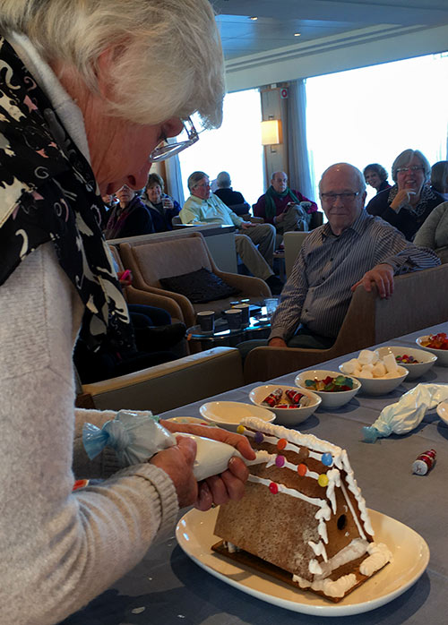 passengers try their hands at making gingerbread houses aboard the Viking Vili