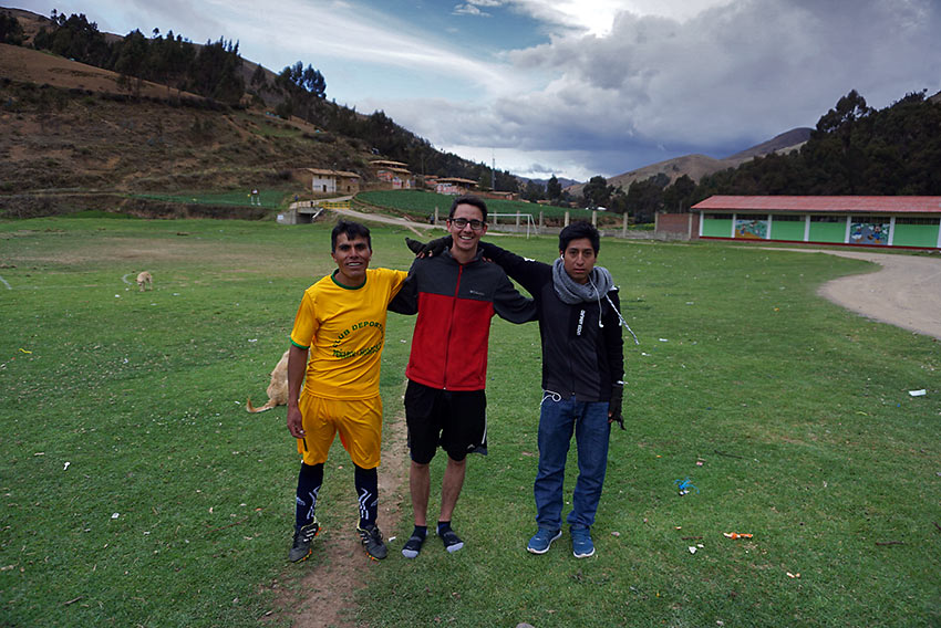 writer after a soccer game with two Peruvians