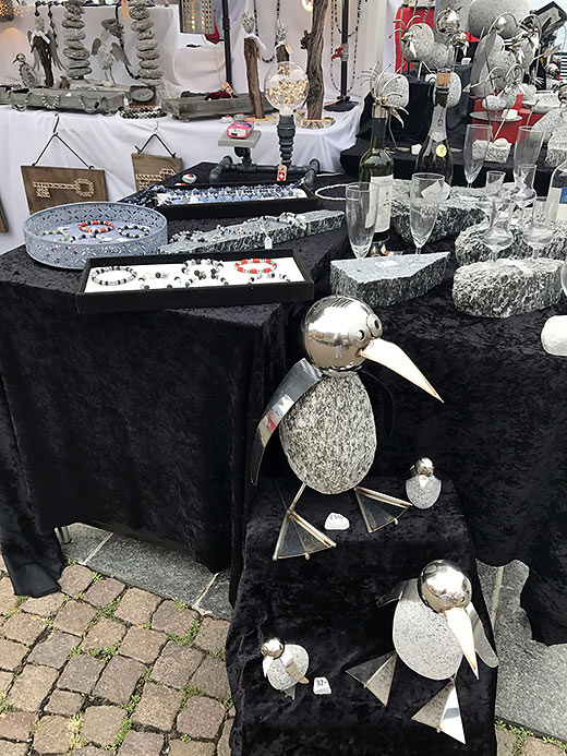 metal and stone sculptures for sale at a version of a farmer’s market