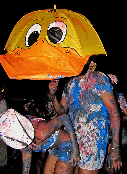 smeared with blue paint at a J’ouvert carnival street party
