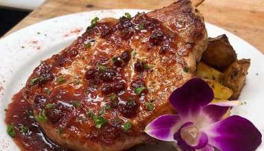 grilled Frenched bone-in pork chop finished with a brandied lingonberry sauce