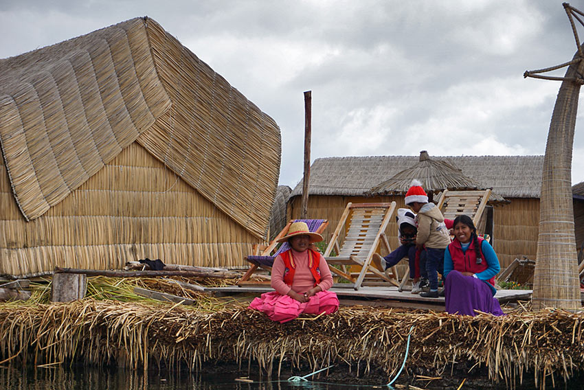 family on a floating reed island, Lake Titicaca, Peru