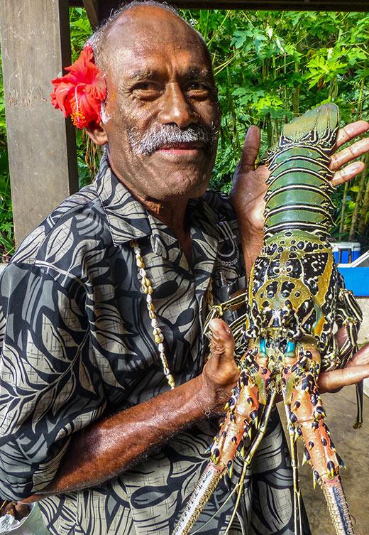 bartender and village elder Manasa with lobster at Yasawa Island Resort, Fiji