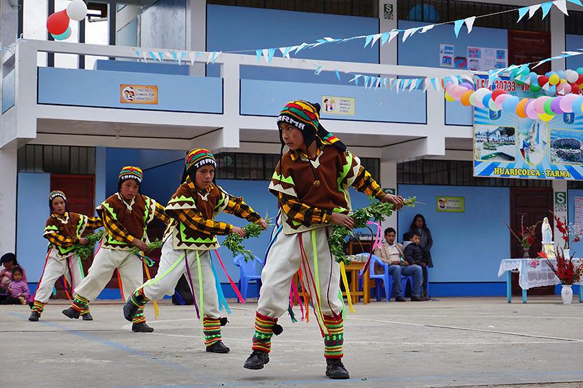 students performing a traditional dance at a primary school anniversary, Peru