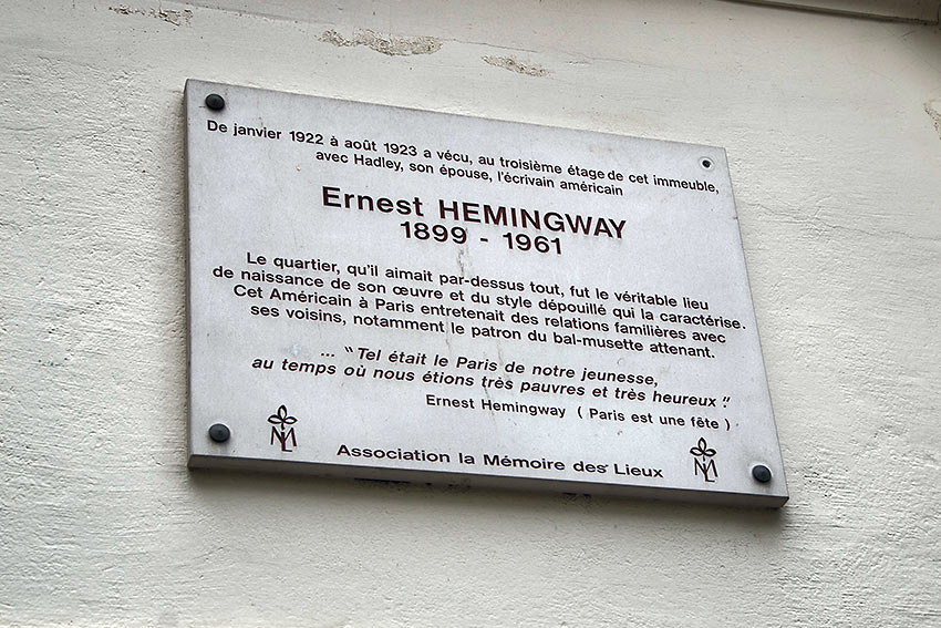 French plaque on a building at the Left Bank in Paris honoring Ernest Hemingway